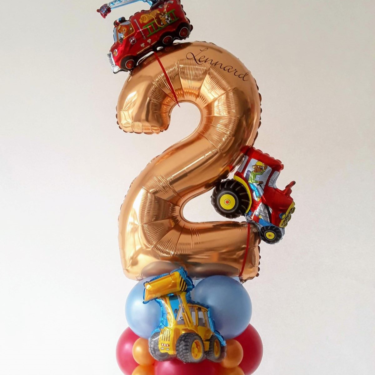 Ballonpräsent zum 2. Geburtstag mit Traktor, Feuerwehrauto und Bagger in Blau, Rot und Gold